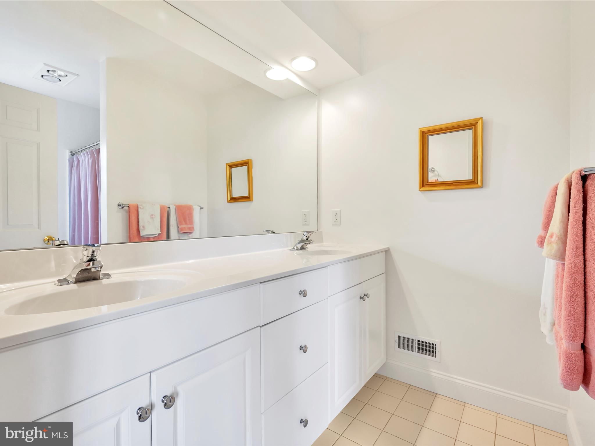 1082 Stillwood Circle Lititz, PA 17543 - Photo 21 of 44 a spacious bathroom with a double vanity sink and a mirror