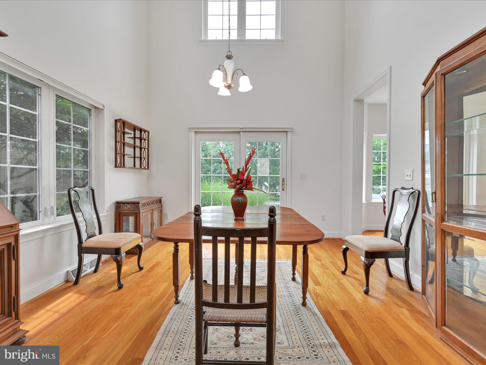 1082 Stillwood Circle Lititz, PA 17543 - Photo 9 of 44 a view of a dining room with furniture a chandelier and wooden floor