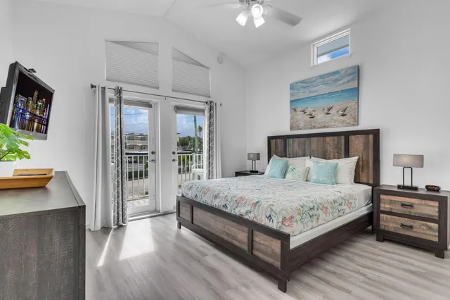 a spacious bedroom with a bed and a table in it