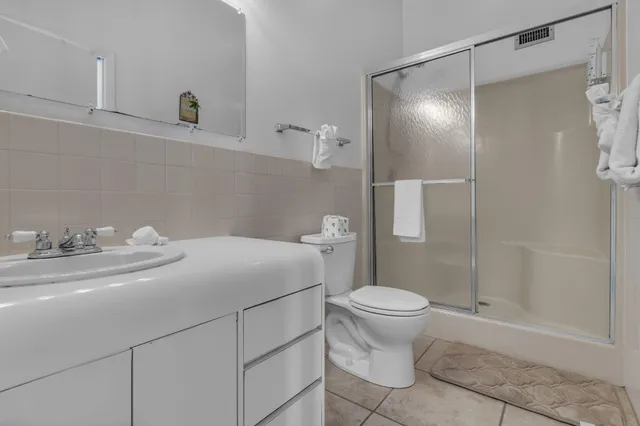a living room with furniture kitchen view and a wooden floor