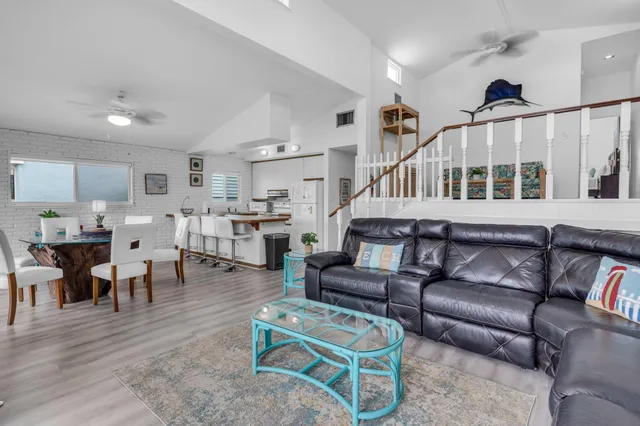 a view of staircase with lots of frames on wall and wooden floor