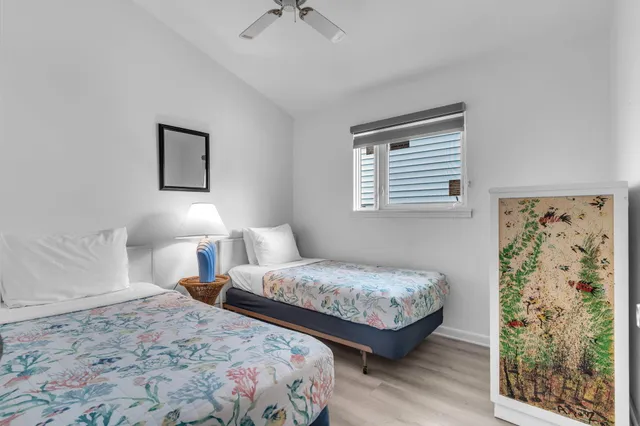 a bedroom with a bed and a painting on the wall