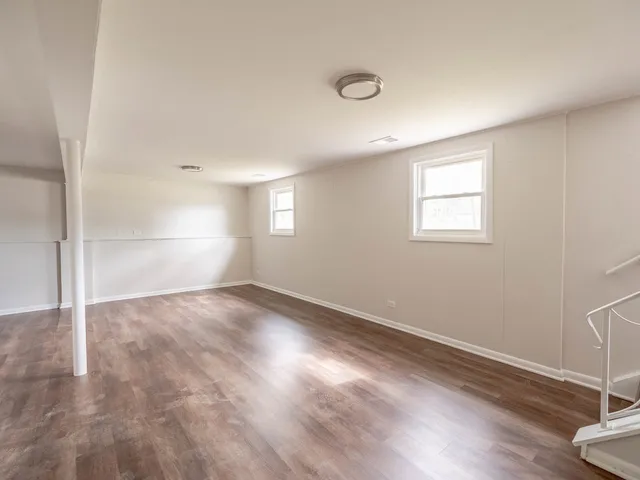 a view of a room with wooden floor