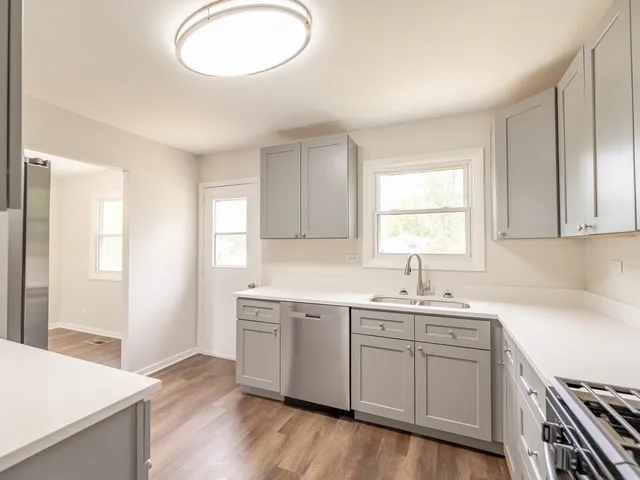 a kitchen with a sink stove and microwave