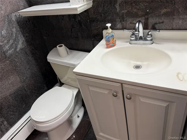 a white toilet sitting next to a bathroom sink