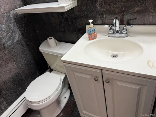 a white toilet sitting next to a bathroom sink