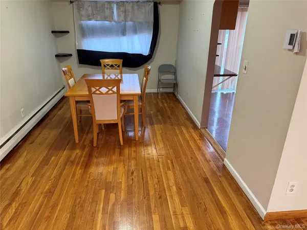 a dining room with furniture wooden floor and a chandelier