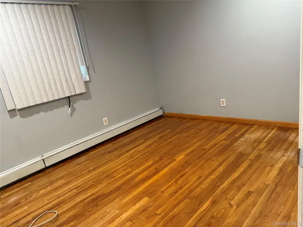 a view of a room with wooden floor and fan
