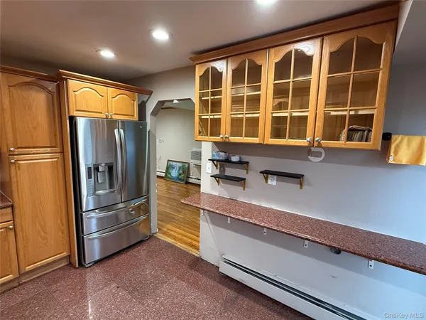 a kitchen with stainless steel appliances granite countertop a refrigerator and a sink