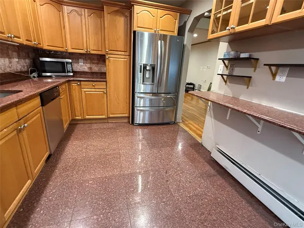 a kitchen with stainless steel appliances a refrigerator and a stove top oven
