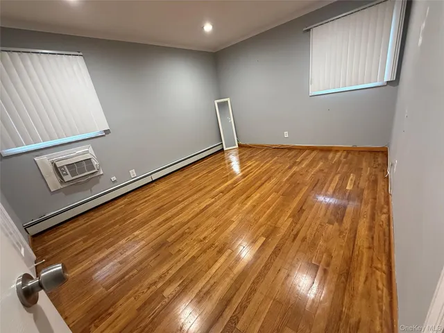a view of room with window and wooden floor