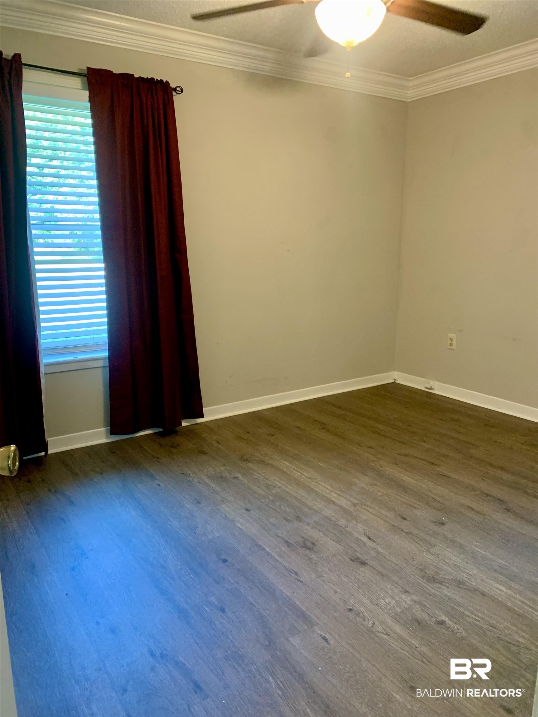 2708 E Road Mobile, AL 36693 - Photo 7 of 12 Spare room featuring dark hardwood / wood-style flooring, ceiling fan, and ornamental molding