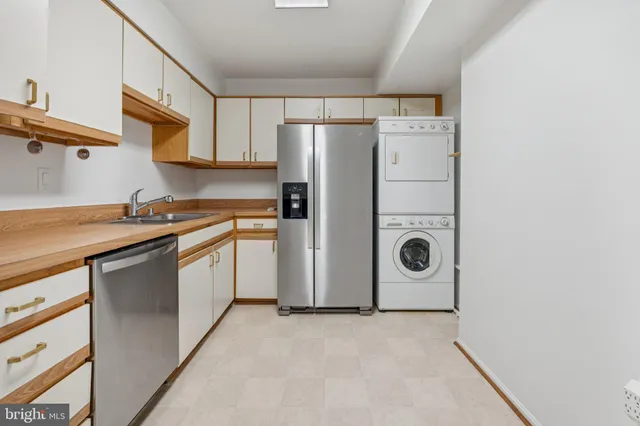 a kitchen with a refrigerator sink stove and cabinets