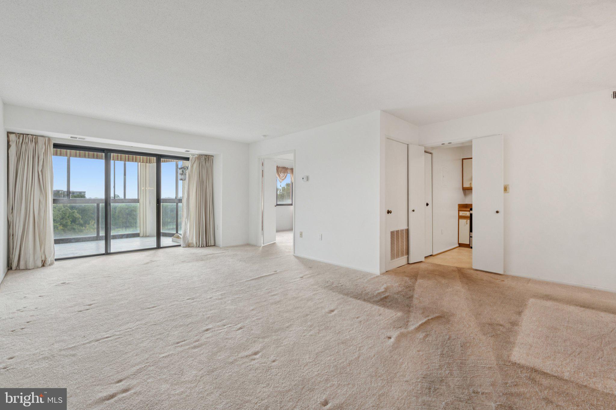 15115 Interlachen Drive, Unit 3815 Silver Spring, MD 20906 - Photo 6 of 27 a view of an empty room with a window