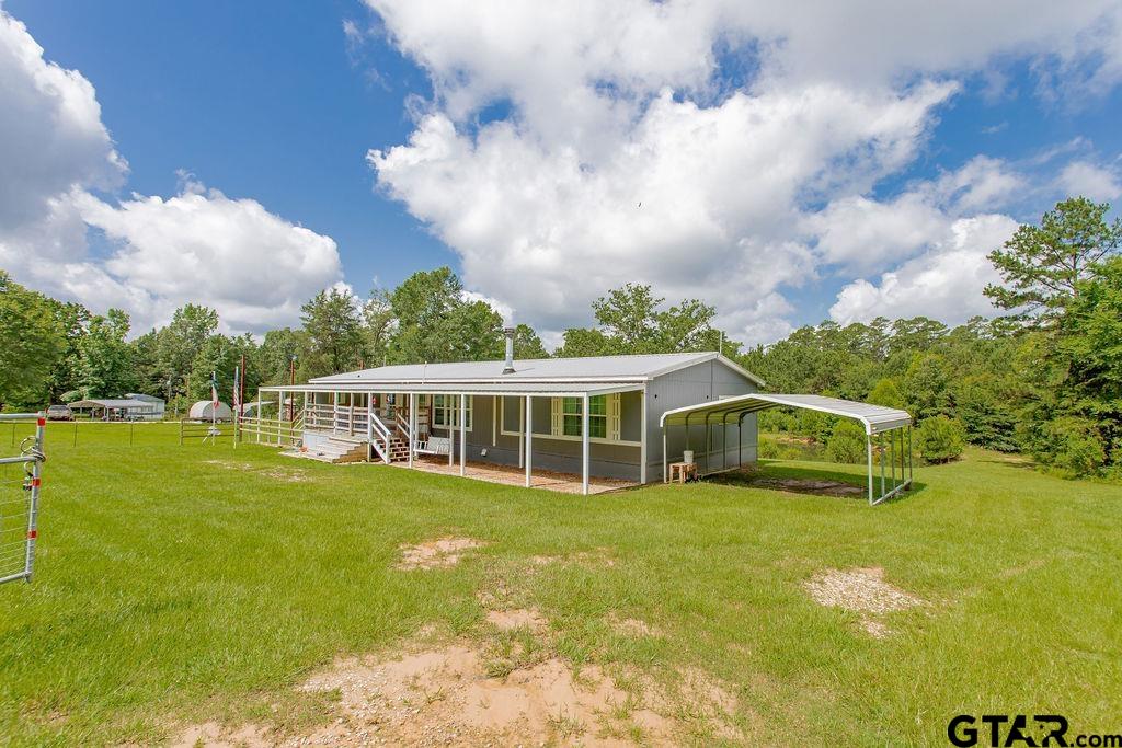 636 Roberson Road Hallsville, TX 75650 - Photo 12 of 46 a view of a house with a big yard and large trees