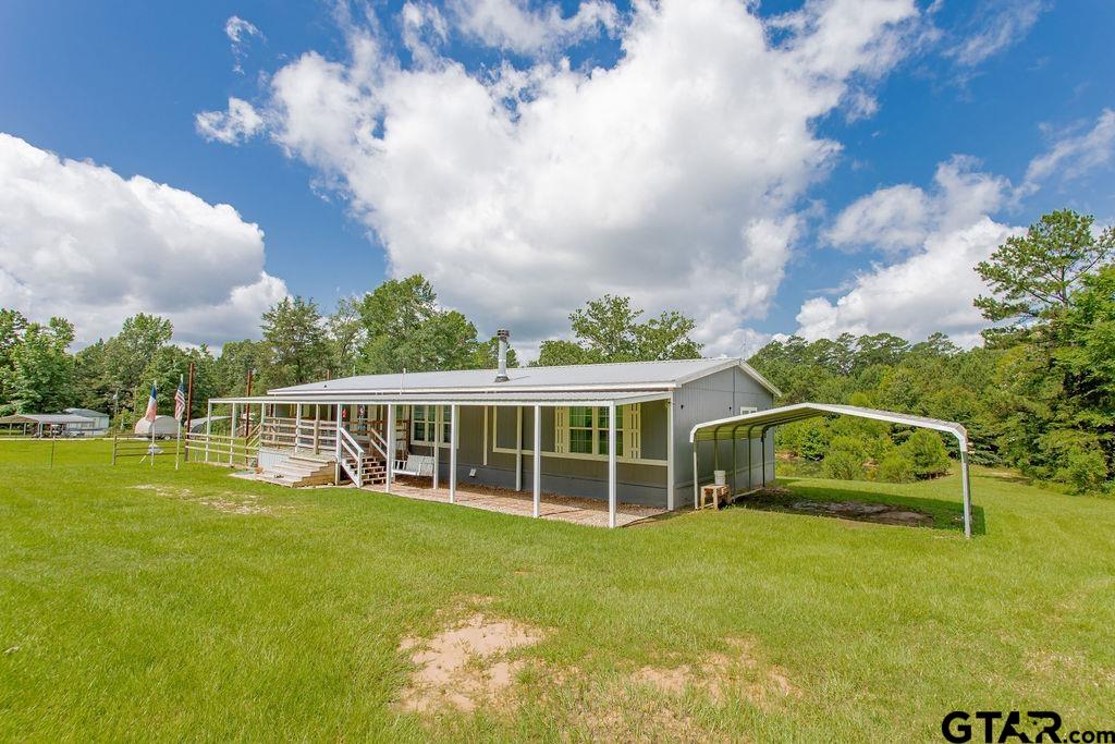 636 Roberson Road Hallsville, TX 75650 - Photo 13 of 46 a view of a house with a big yard and large trees