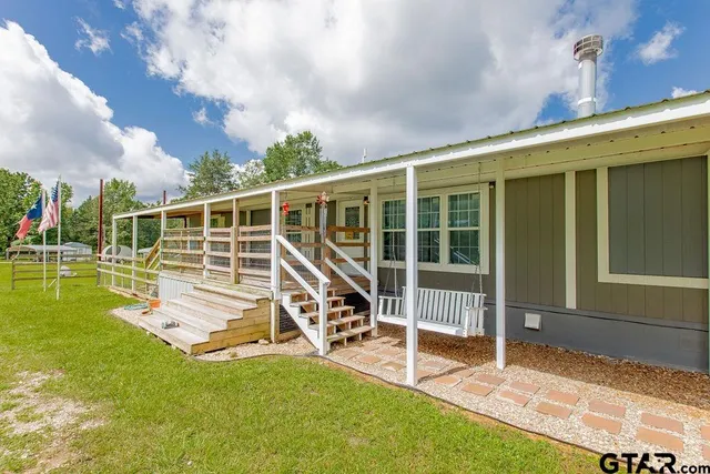 a view of a house with backyard and porch