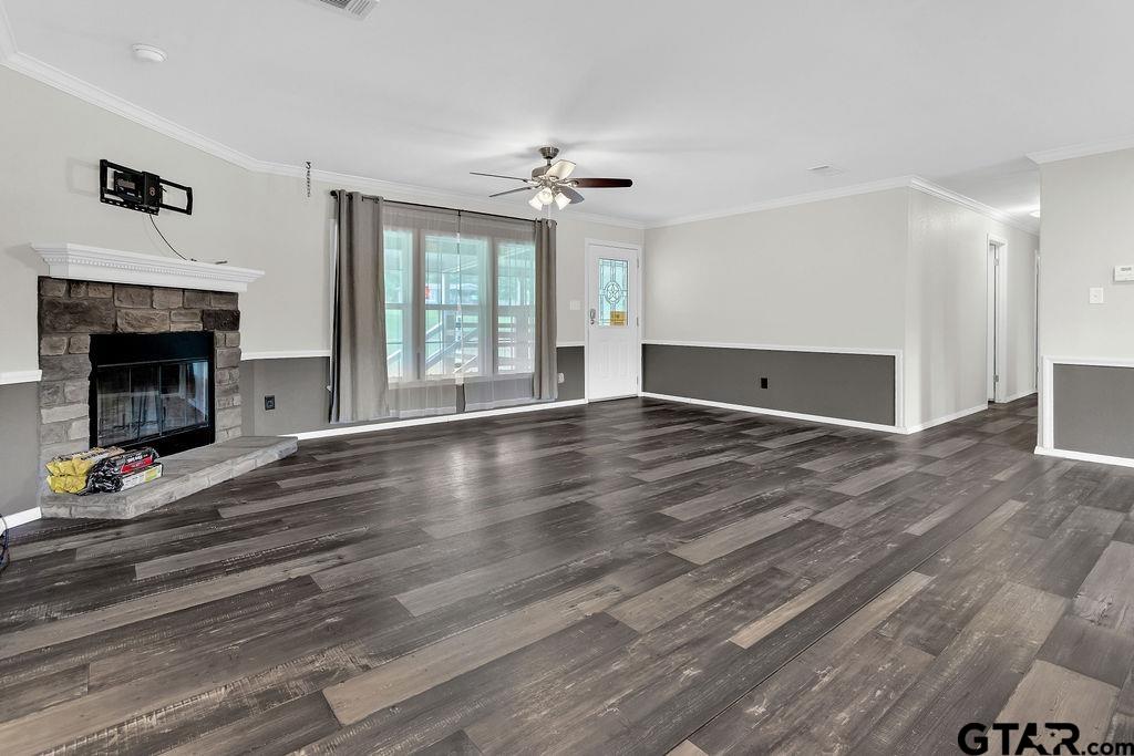 636 Roberson Road Hallsville, TX 75650 - Photo 21 of 46 an empty room with wooden floor fireplace and windows