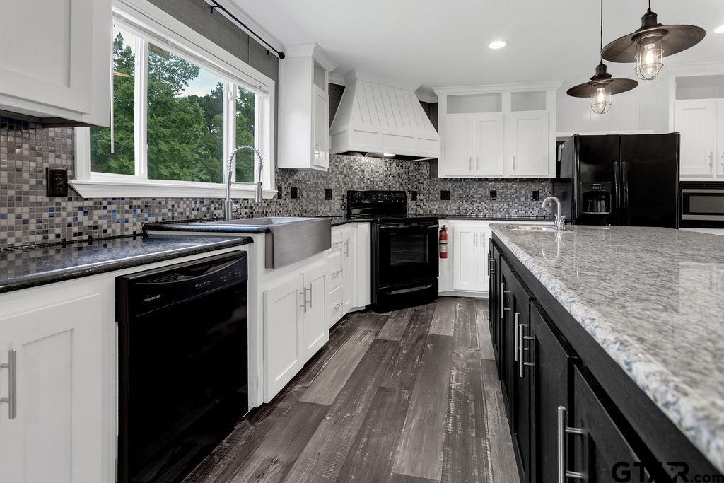 636 Roberson Road Hallsville, TX 75650 - Photo 23 of 46 a kitchen with stainless steel appliances granite countertop hardwood floor sink stove and granite counter top