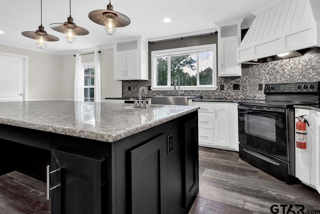 636 Roberson Road Hallsville, TX 75650 - Photo 24 of 46 a kitchen with granite countertop kitchen island stainless steel appliances a sink stove and cabinets