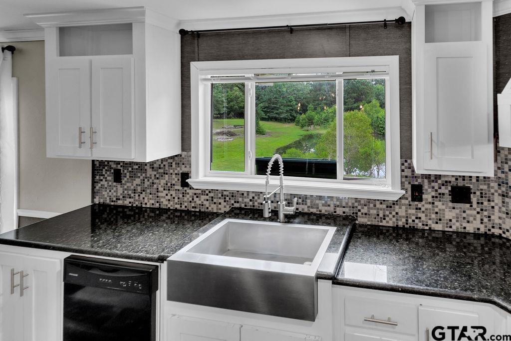 636 Roberson Road Hallsville, TX 75650 - Photo 26 of 46 a kitchen with granite countertop a sink and a white wooden cabinets