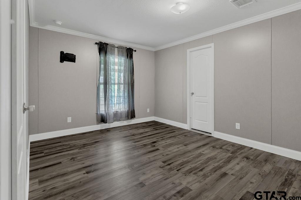 636 Roberson Road Hallsville, TX 75650 - Photo 33 of 46 a view of an empty room with wooden floor and a window