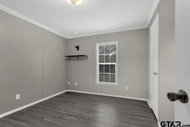 a bathroom with a granite countertop sink a toilet and a mirror