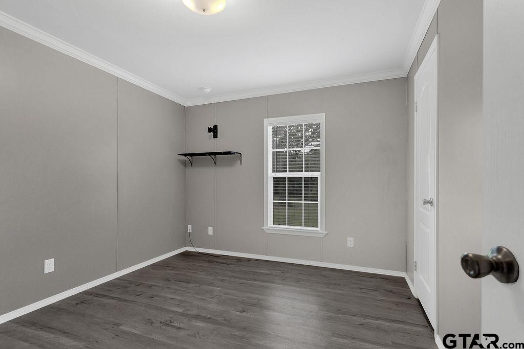636 Roberson Road Hallsville, TX 75650 - Photo 35 of 46 an empty room with wooden floor and windows