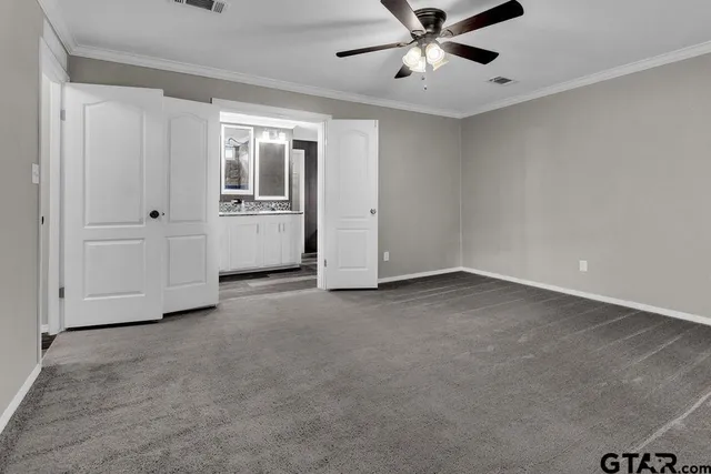 a bathroom with a granite countertop sink and a large mirror