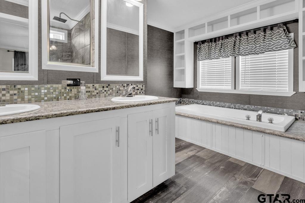 636 Roberson Road Hallsville, TX 75650 - Photo 40 of 46 a bathroom with a granite countertop sink and a large mirror