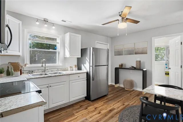 a kitchen with a refrigerator and a sink