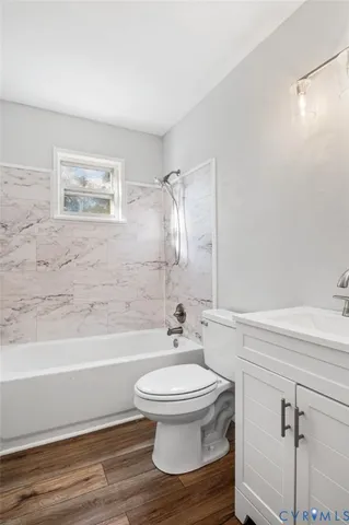 a bathroom with a toilet a sink and bathtub