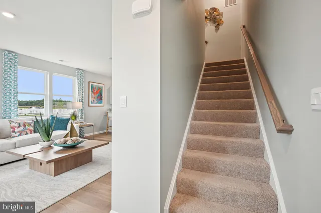 a living room with furniture and stairs