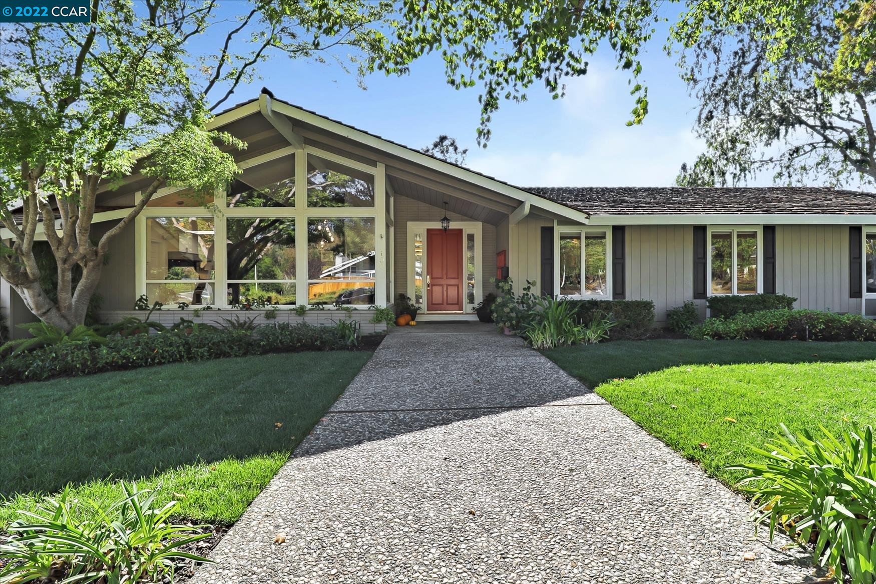 100 Corliss Drive Moraga, CA 94556 - Photo 1 of 1 a front view of a house with a yard and potted plants