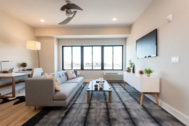 a living room with furniture and a large window