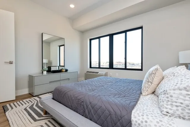 a bedroom with a large bed and a large window