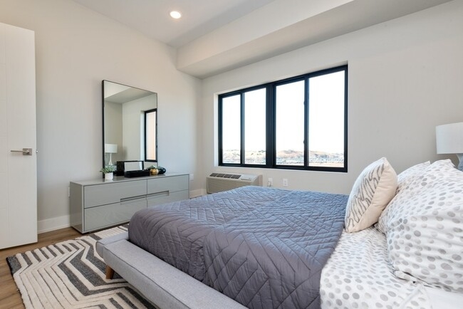 1 Flagship Street, Unit 219 Bayonne, NJ 07002 - Photo 7 of 15 a bedroom with a large bed and a large window