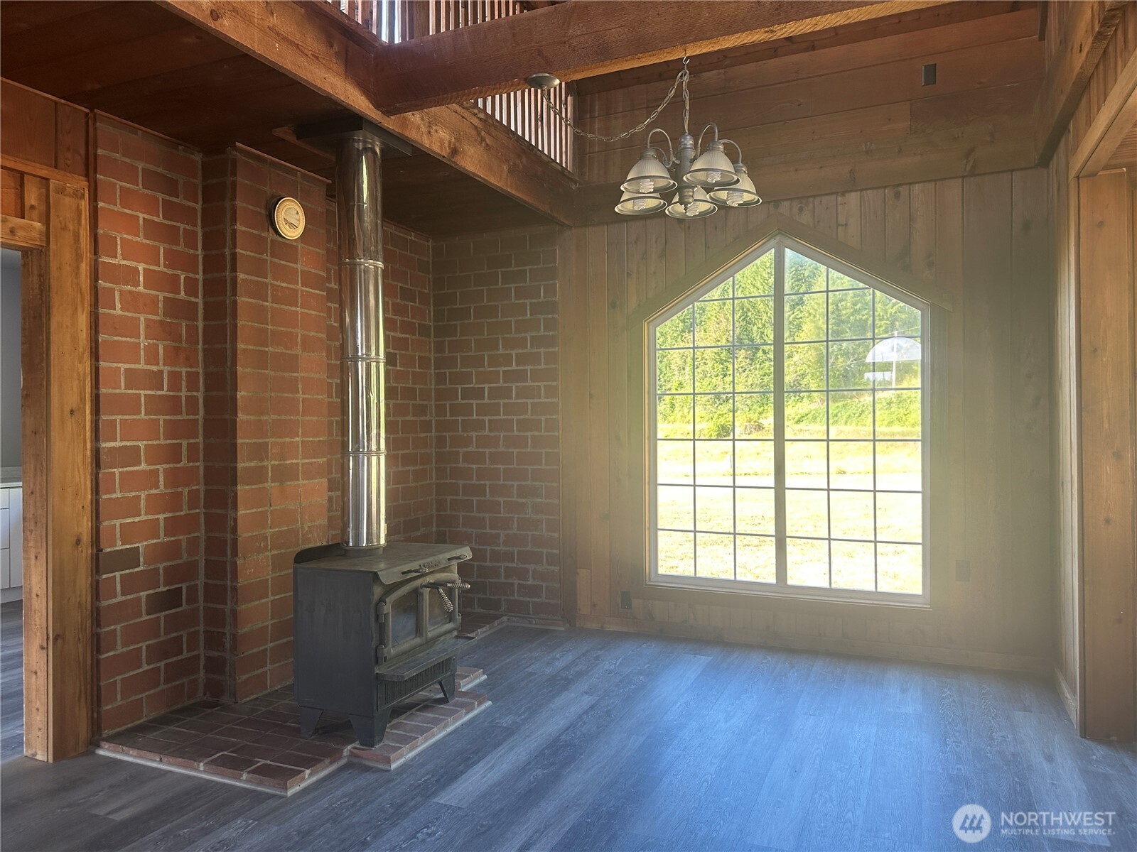 720 Leland Valley Road East Quilcene, WA 98376 - Photo 12 of 37 a view of a livingroom with a window and wooden floor