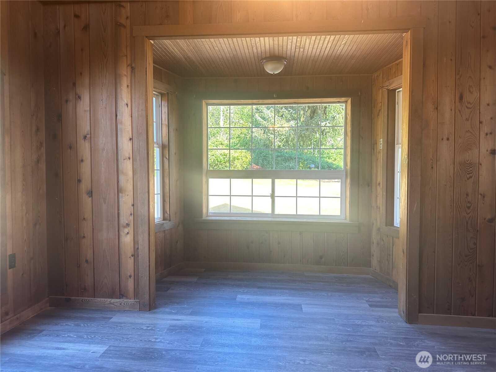 720 Leland Valley Road East Quilcene, WA 98376 - Photo 13 of 37 an empty room with wooden floor and windows