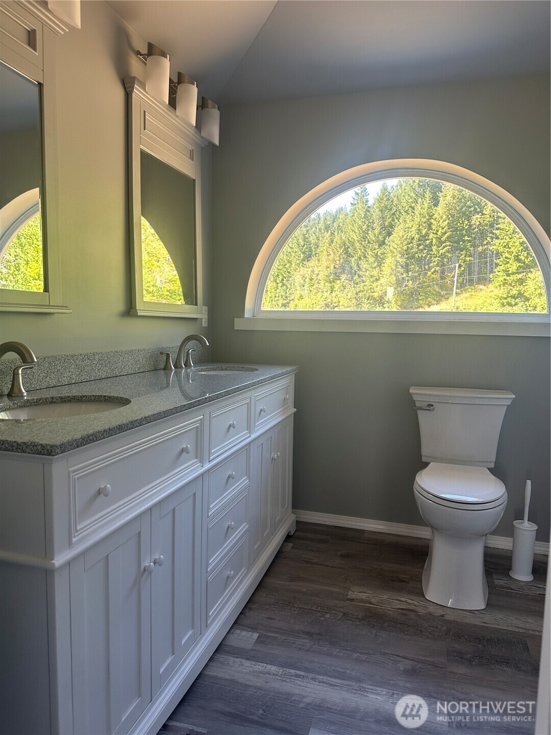 720 Leland Valley Road East Quilcene, WA 98376 - Photo 20 of 37 a bathroom with a granite countertop toilet a sink and a large mirror