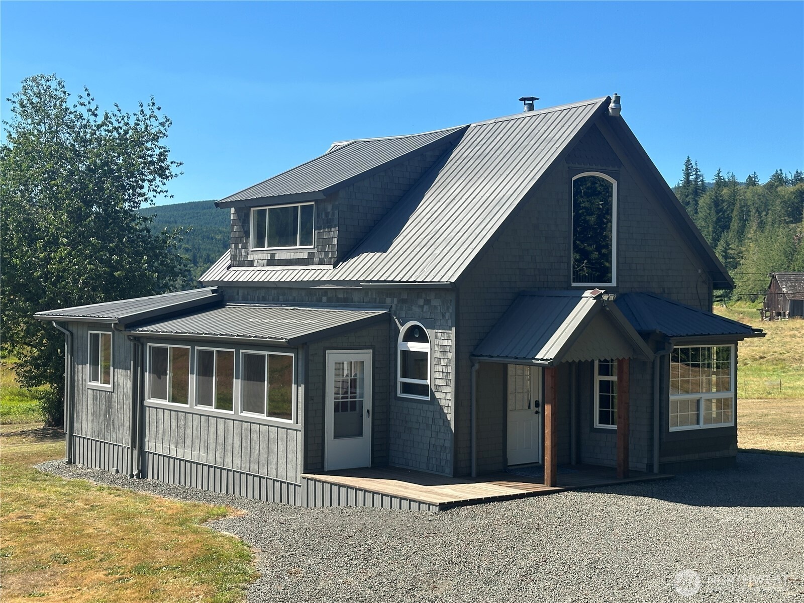 720 Leland Valley Road East Quilcene, WA 98376 - Photo 2 of 37 a front view of a house with garage