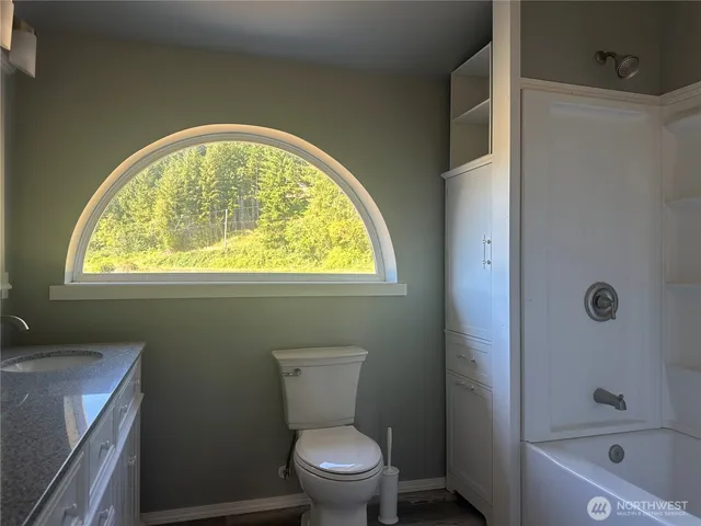 a bathroom with a toilet sink and bathtub