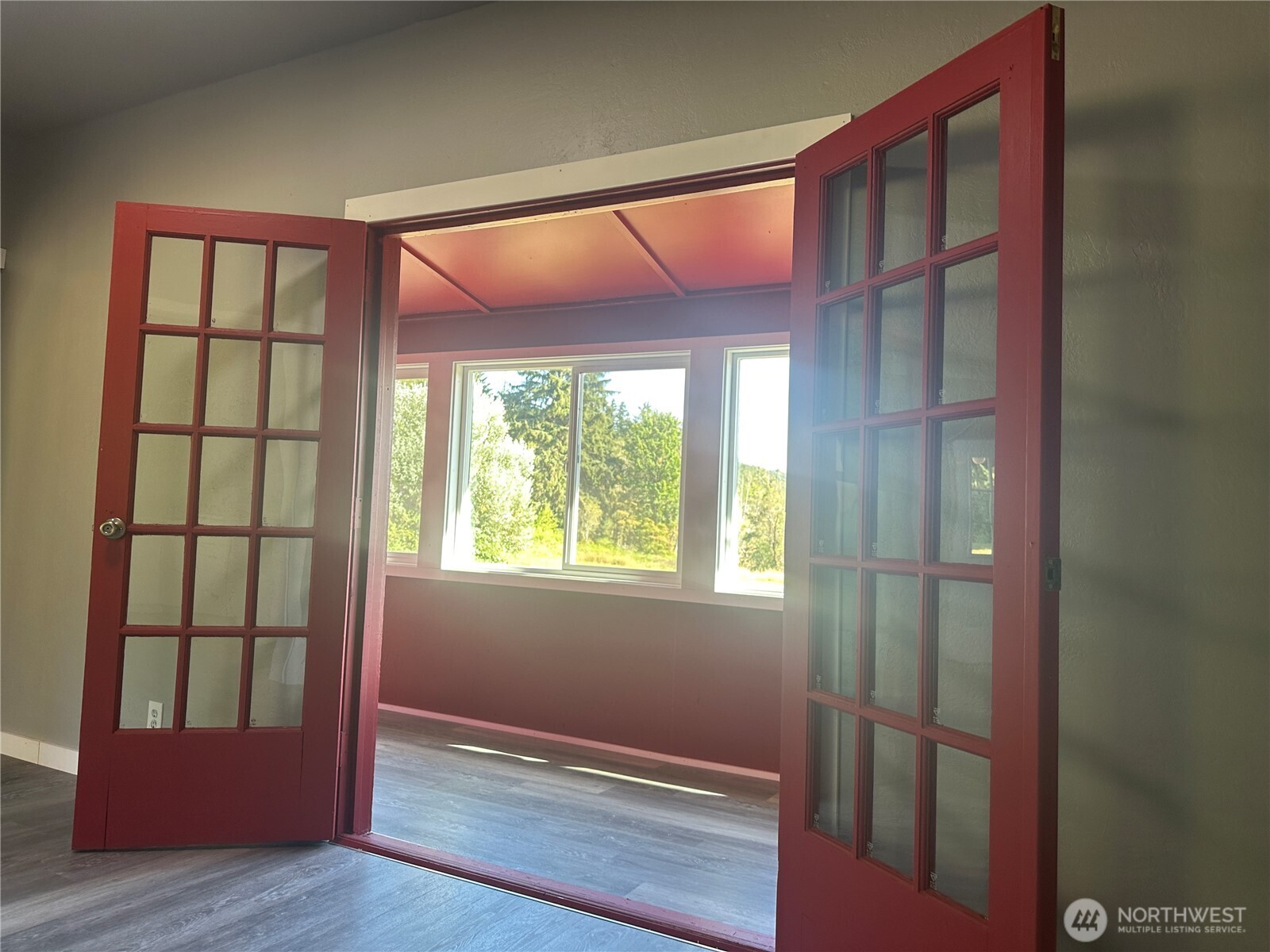 720 Leland Valley Road East Quilcene, WA 98376 - Photo 24 of 37 a view of an empty room with wooden floor and a window