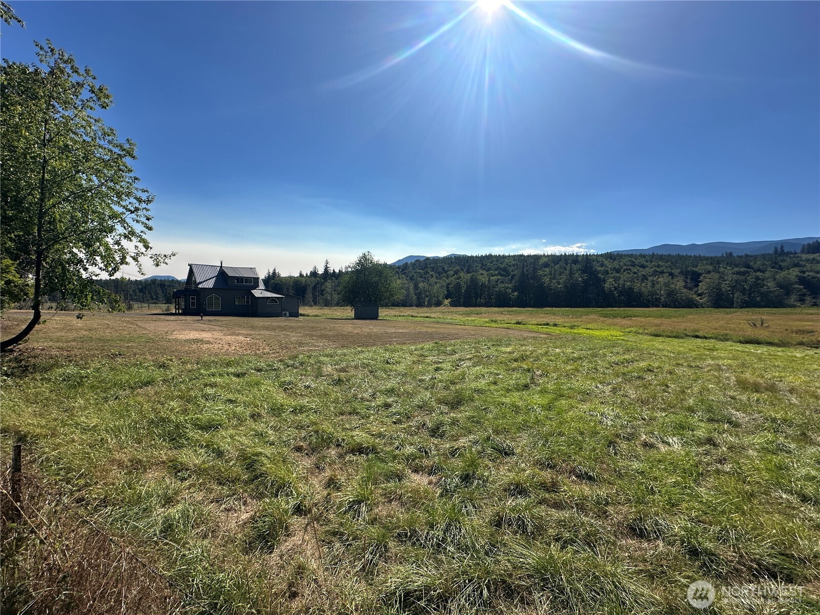 720 Leland Valley Road East Quilcene, WA 98376 - Photo 32 of 37 a view of a yard with sunset view