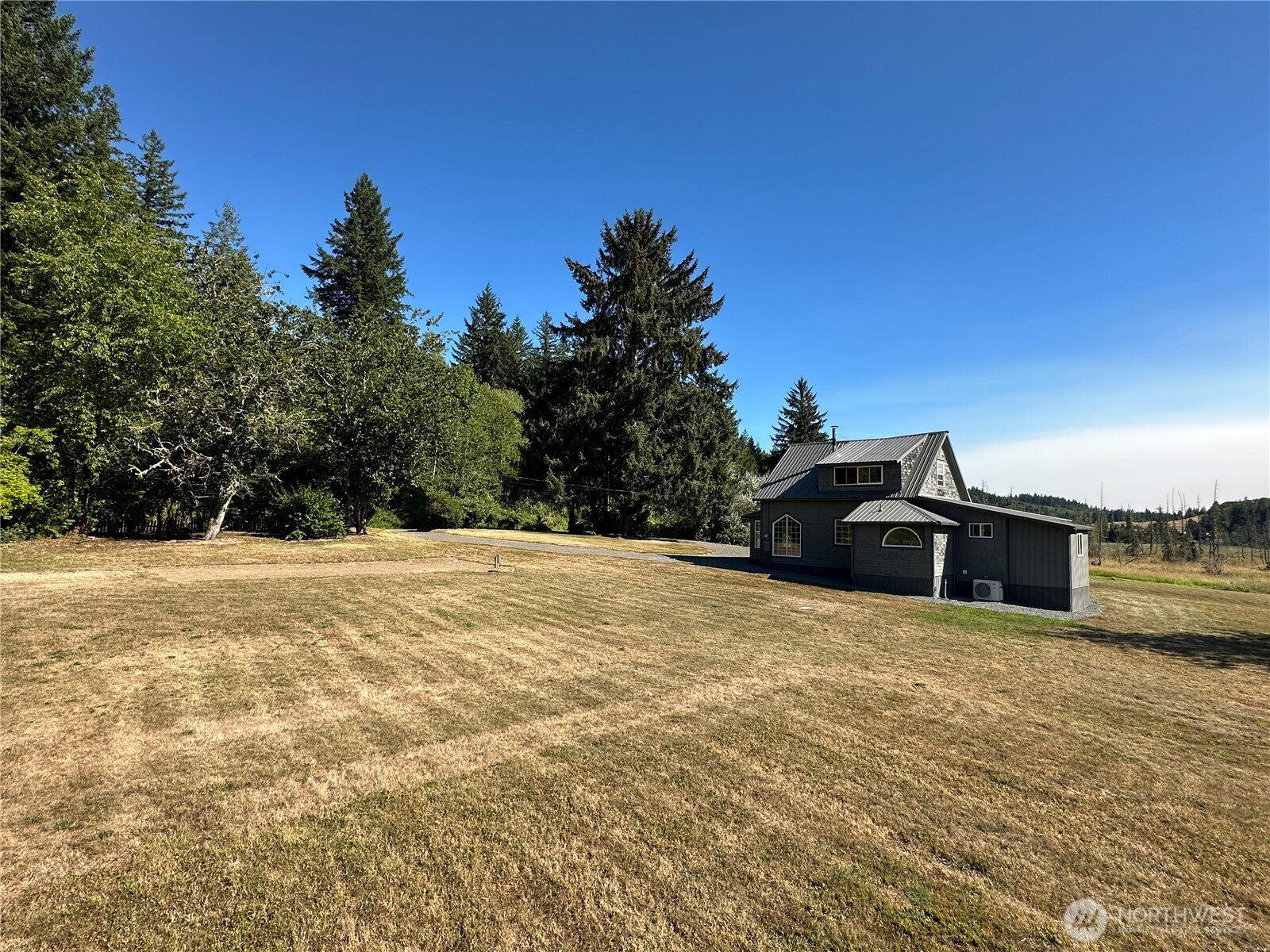 720 Leland Valley Road East Quilcene, WA 98376 - Photo 33 of 37 a view of a house with a yard