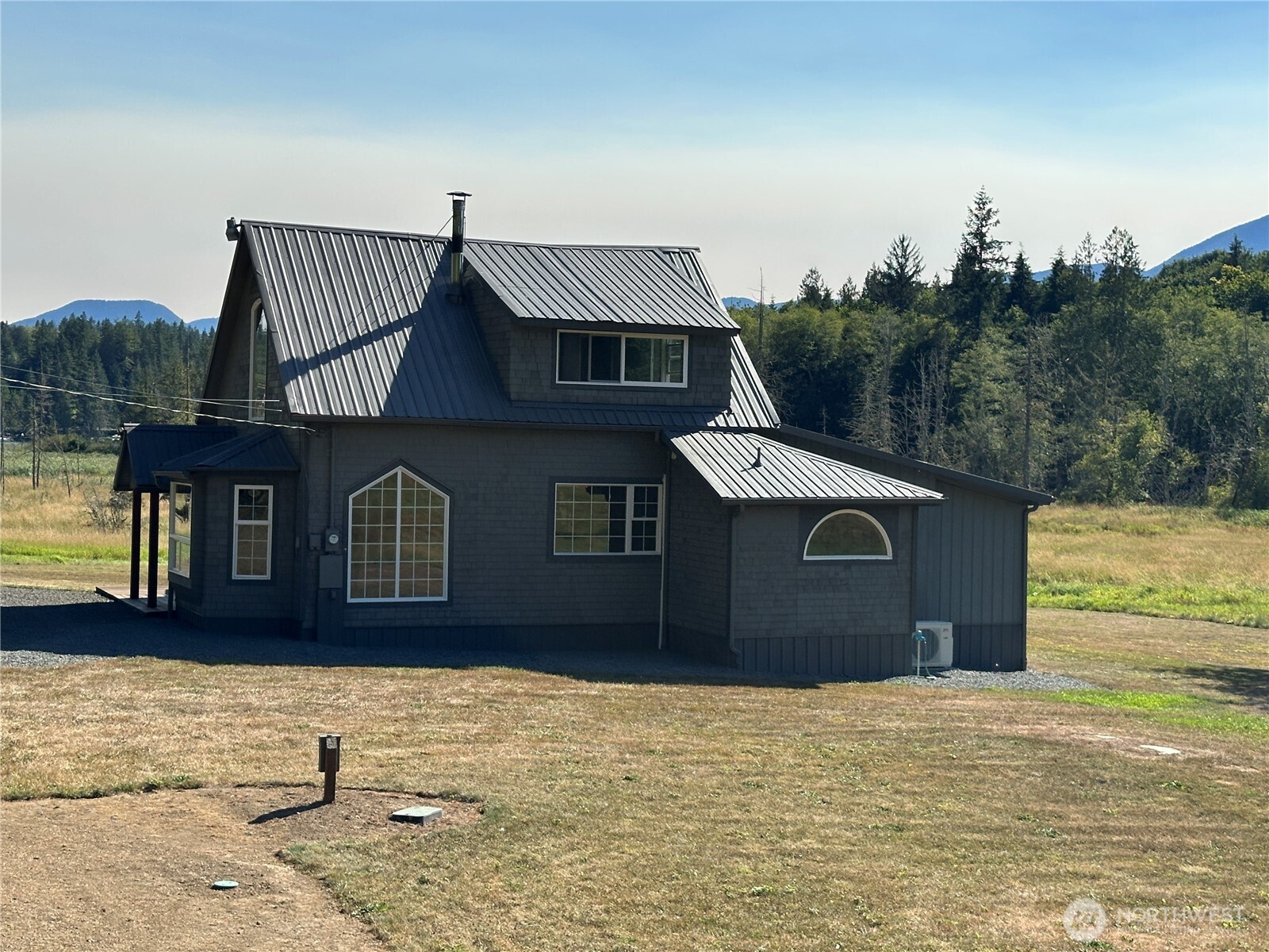 720 Leland Valley Road East Quilcene, WA 98376 - Photo 5 of 37 a front view of a house with a yard