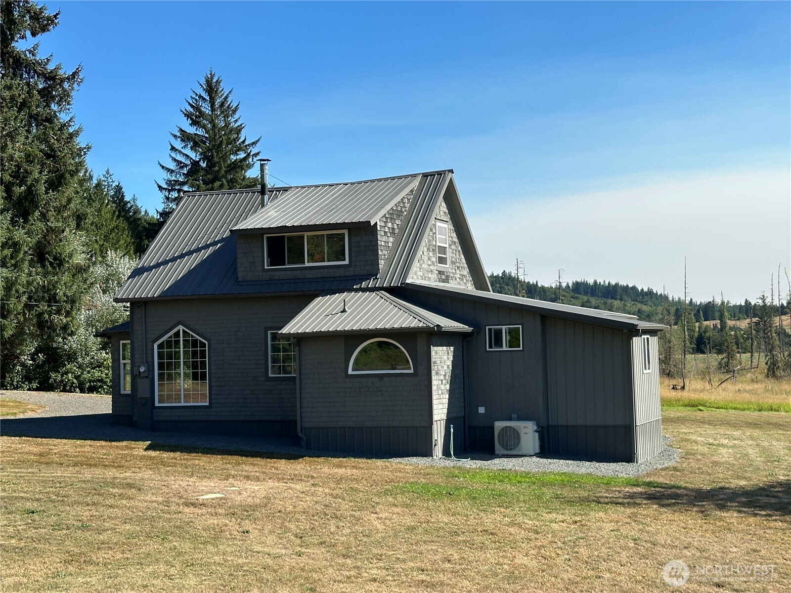 720 Leland Valley Road East Quilcene, WA 98376 - Photo 6 of 37 a front view of a house with a yard