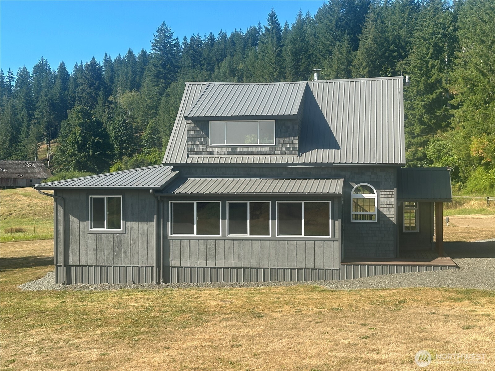 720 Leland Valley Road East Quilcene, WA 98376 - Photo 10 of 37 a view of a house with a swimming pool