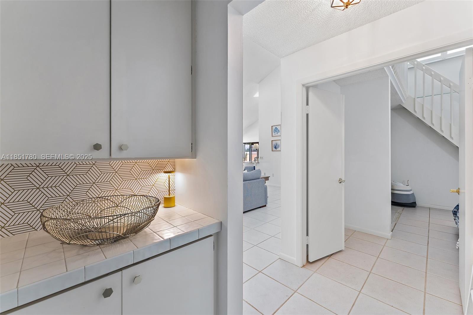 101 Sand Pine Drive, Unit 101 Jupiter, FL 33477 - Photo 19 of 33 a kitchen with stainless steel appliances granite countertop a refrigerator and a sink