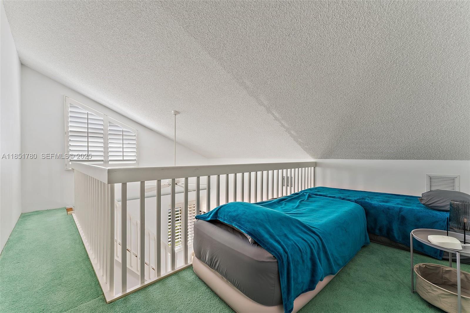 101 Sand Pine Drive, Unit 101 Jupiter, FL 33477 - Photo 22 of 33 a bedroom with a bed and a window